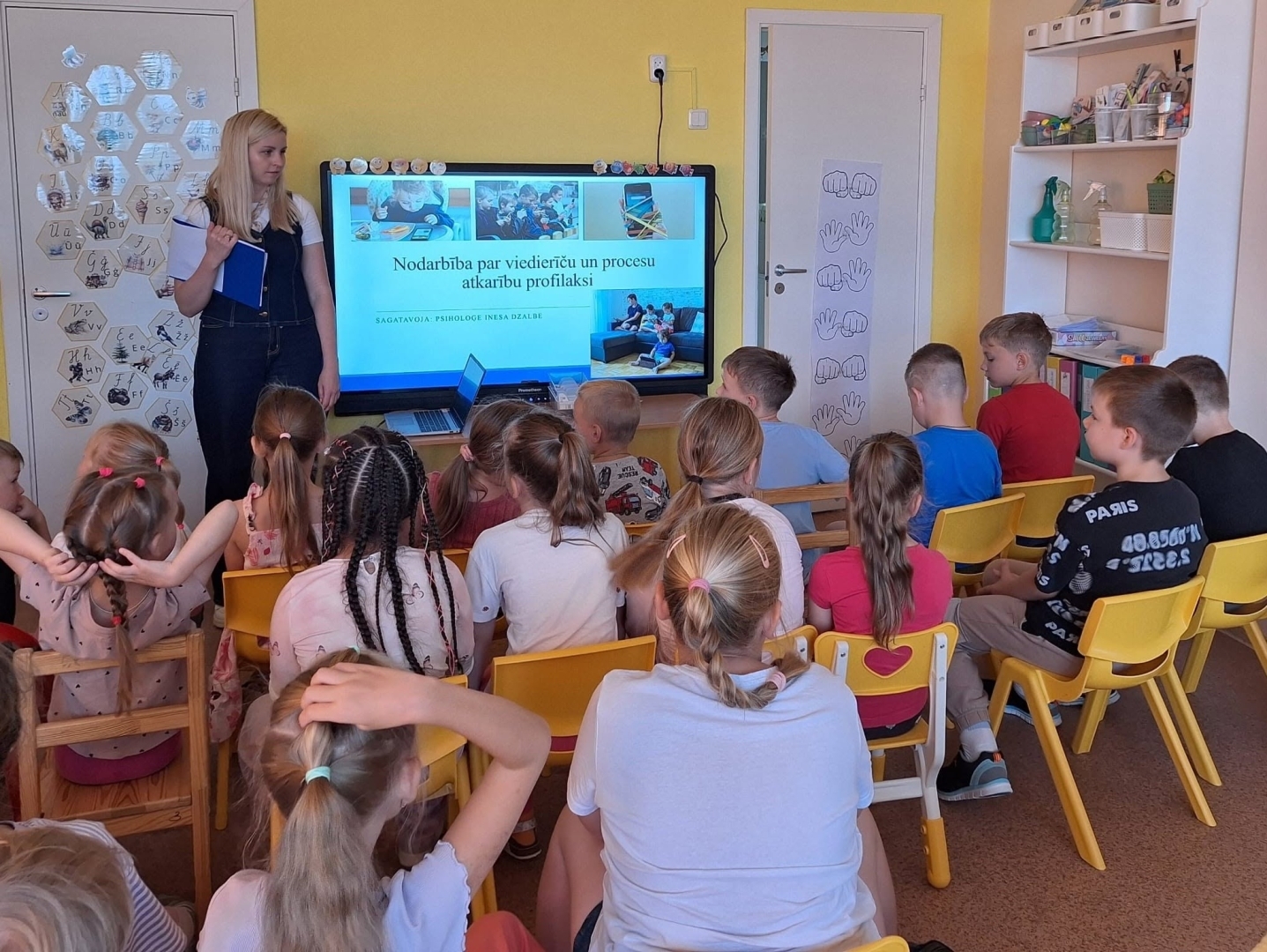 Bērni klausās nodarbību par viedierīcēm