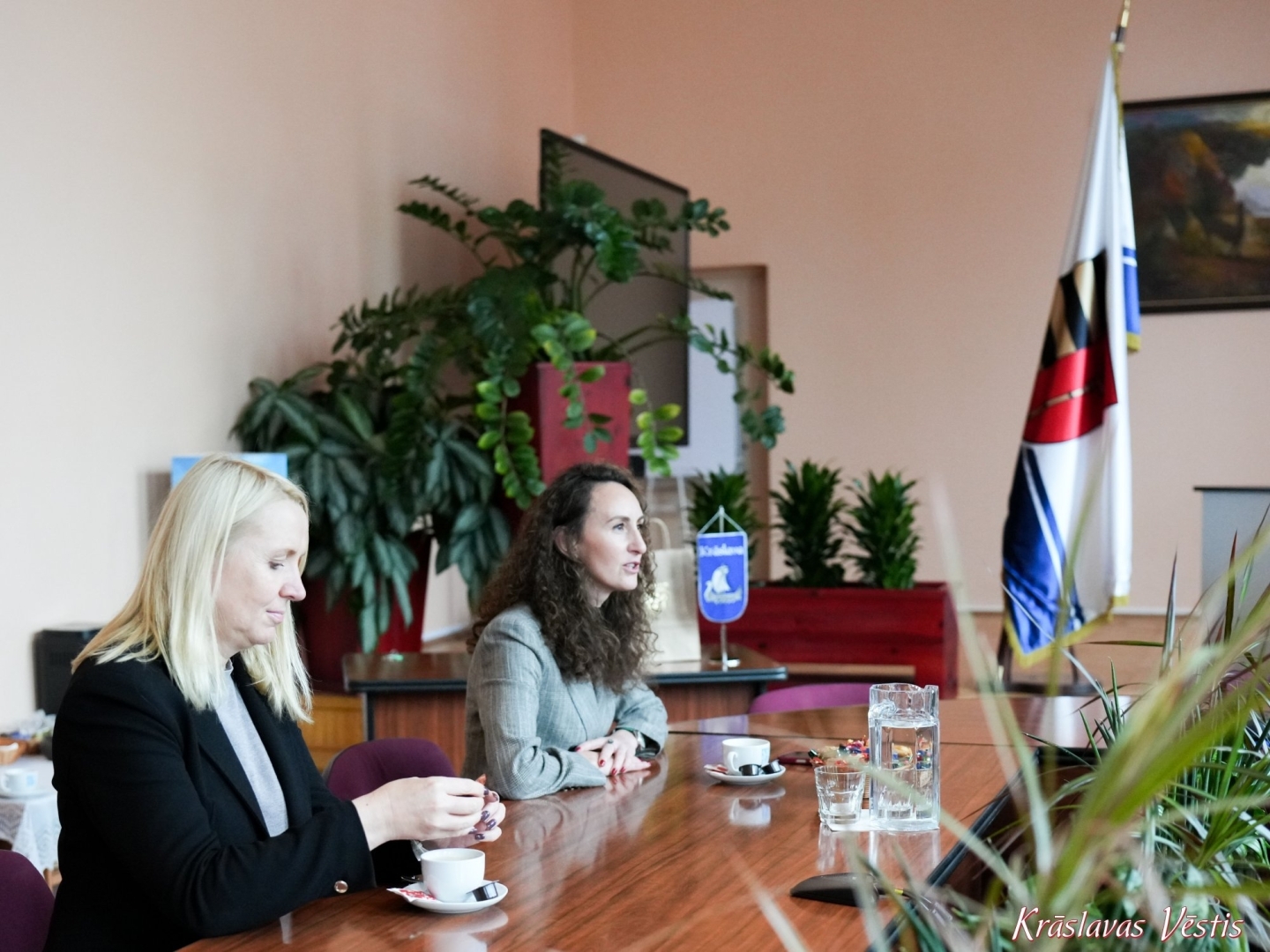 Divas personas pie galda pašvaldības telpās