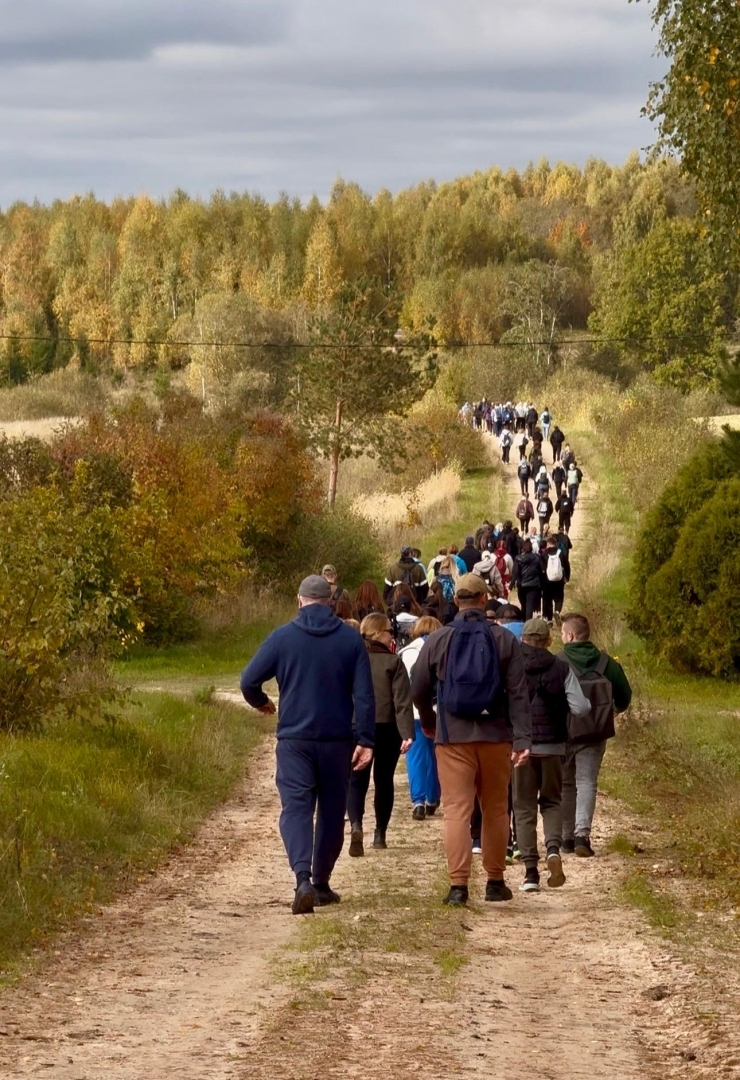 Pārgājiena dalībnieki dodas pa meža taku