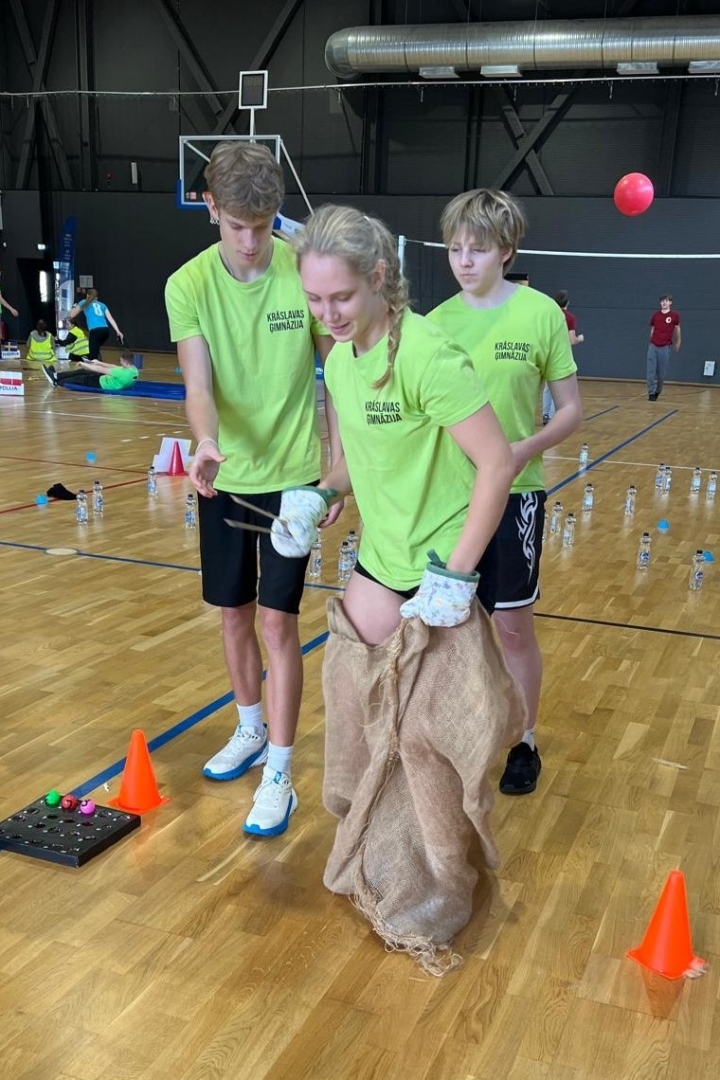 Skolēni piedalās sportiskā stafetē ar maisiem