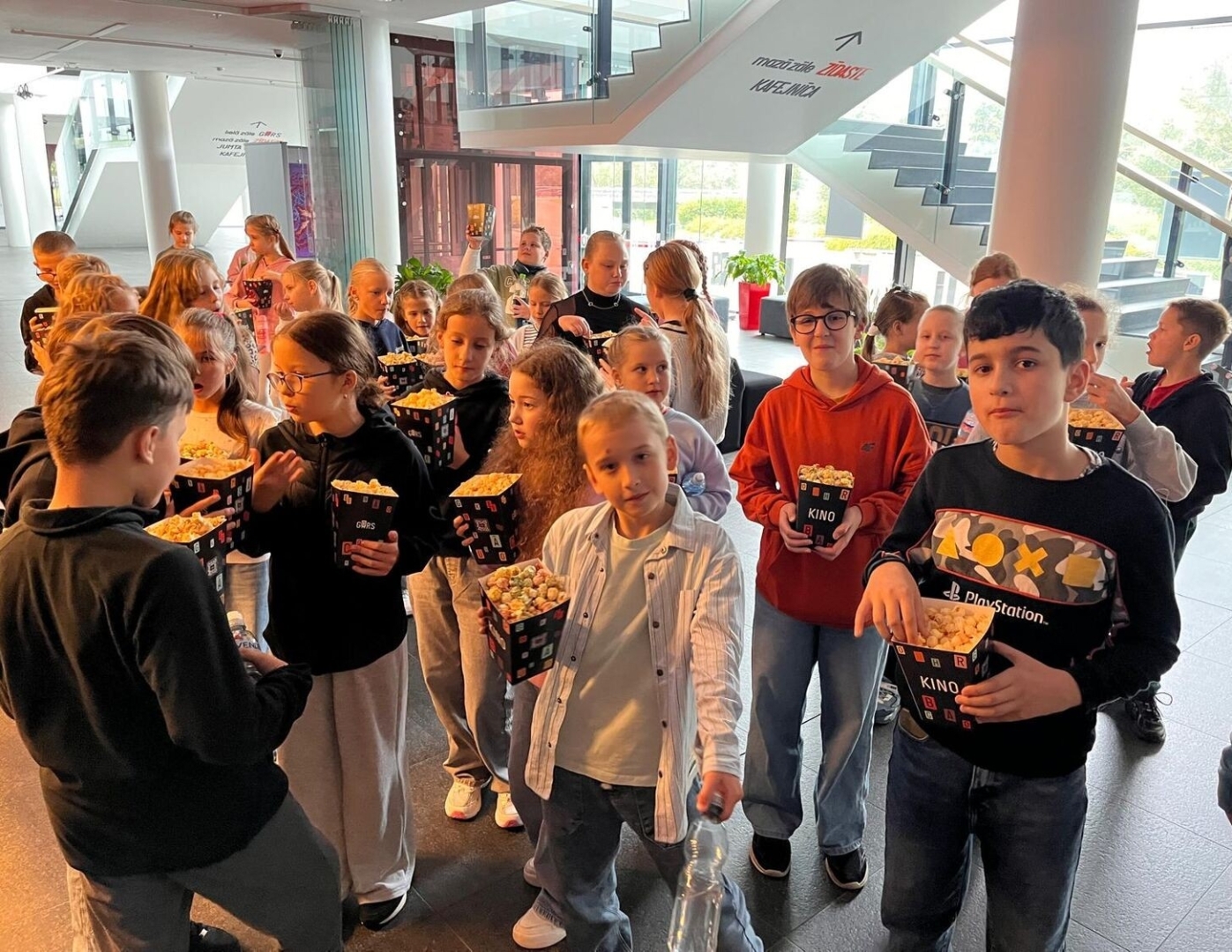 Bērni ar popkorna turzām kinoteātrī