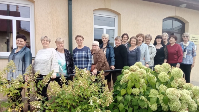 Pasākuma dalībnieku kopbilde pie bibliotēkas
